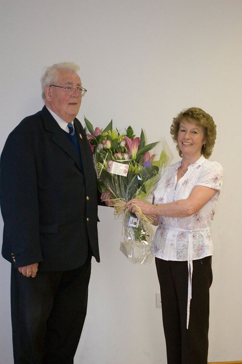 League President Peter McPherson presents Gill Herbert a Bouquet of flowers