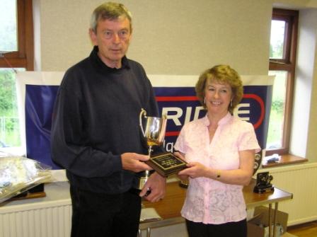 Hardwicke secretary Stan Hine receiving the Dave Herbert Sportsmanship Trophy from Jill Herbert