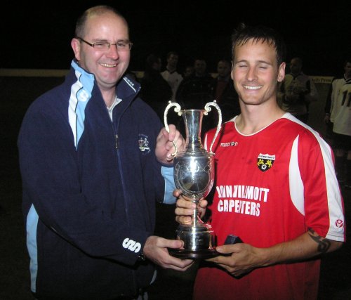 Patchway Town Captain Mark Palmer receives the Les James Trophy from Mel Wheeler.