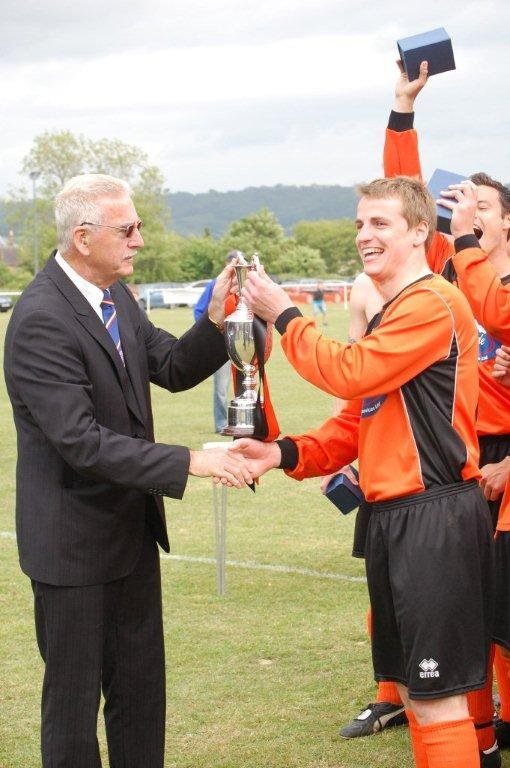 Henbury Captain Eddie Howells presented with the Les James Cup by League Chairman Robin Stewart